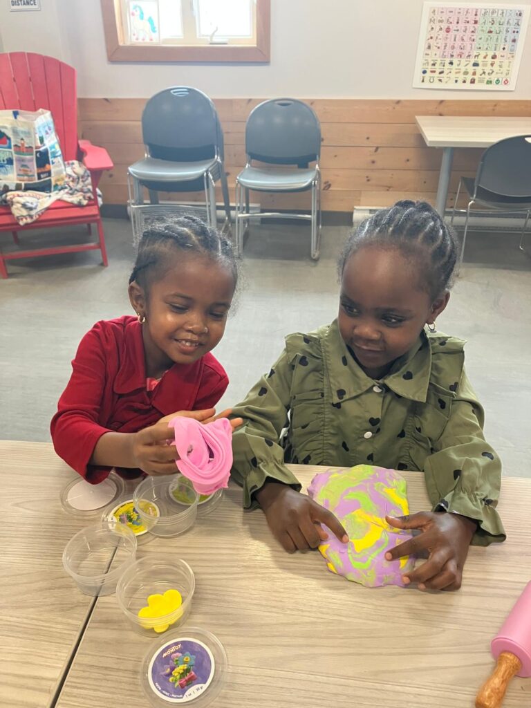 Two children playing with play dough