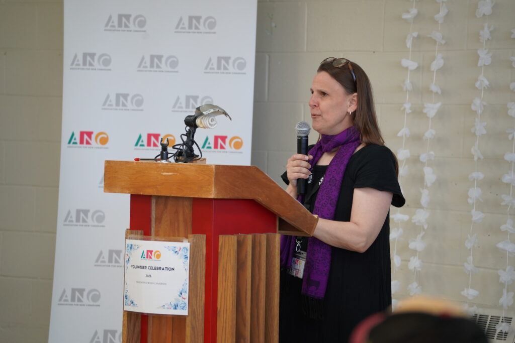 Woman speaking at a podium. 